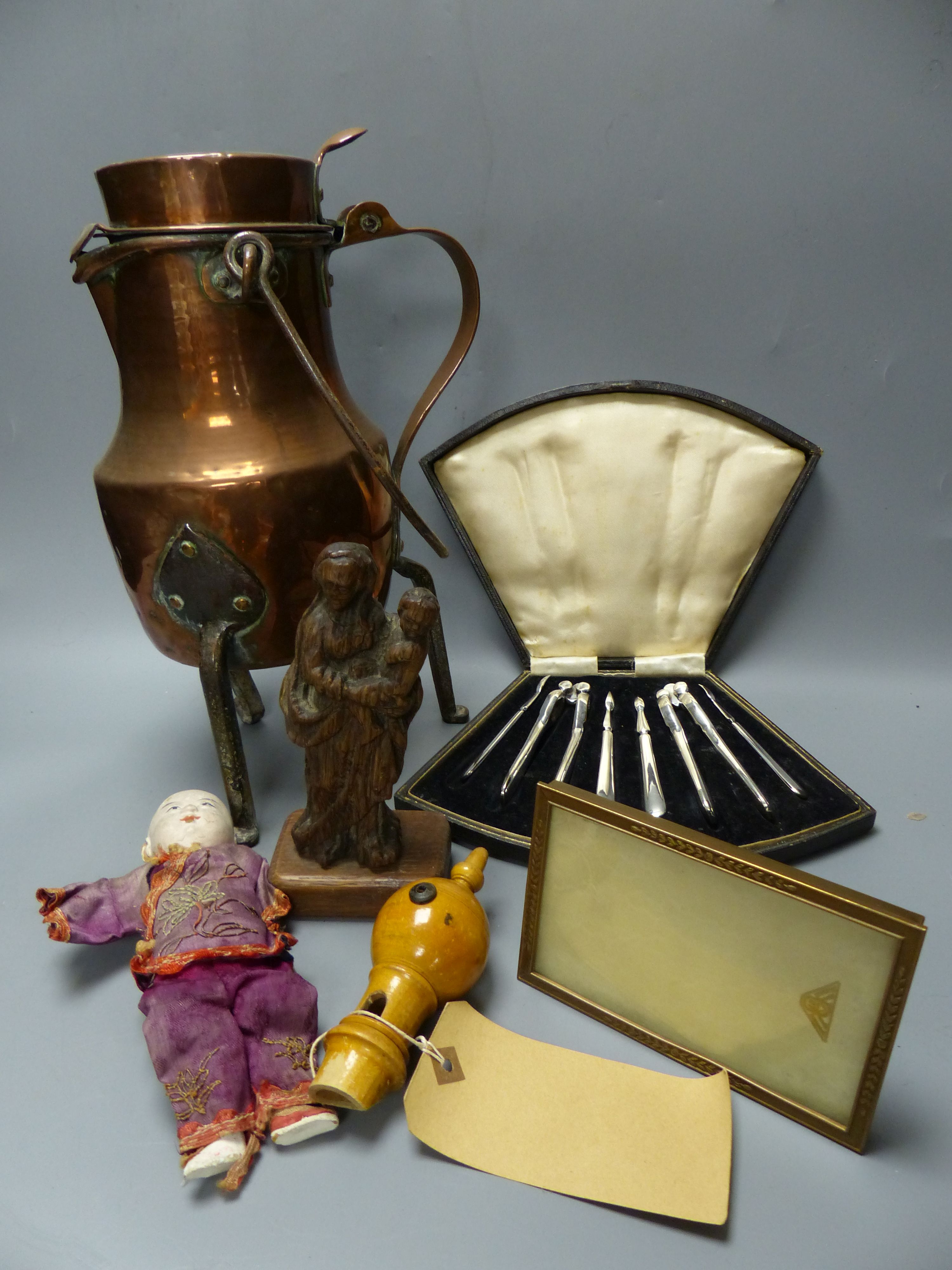 A quantity of mixed collectables including an oval mahogany tray, a lidded copper vessel, a Chinese doll, a treen whistle etc.